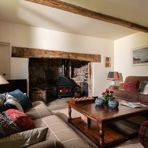 Lounge with 3 sofas and woodburner